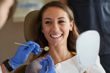 A smiling woman in a Dentist chair 