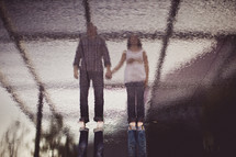 a couple reflected on water