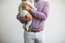 a father holding an infant 