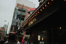 Uno's pizzeria and people on a downtown sidewalk 