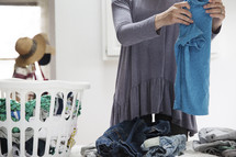a woman folding laundry 