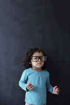 toddler girl wearing reading glasses 