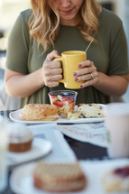 woman eating breakfast and praying before her meal 