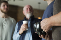 men's group with coffee mugs