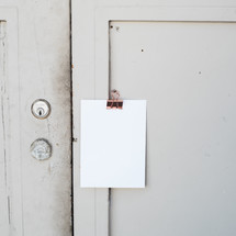 clipboard hanging outside a door 