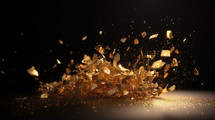 Gold dust and pieces falling on a black background. 