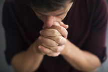 overhead of a man in prayer 
