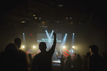 fans in a audience praising God at a worship service 