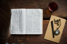 Reading the Bible on a wooden table.