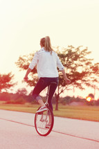 woman riding a unicycle 