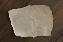 Blank Piece of Parchment Paper on a Wood Background