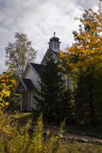 A traditional chapel amongst beautiful trees in autumn