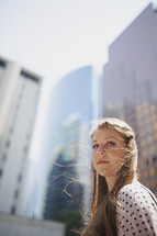 a young girl by buildings