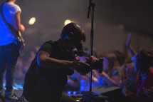 man with a videocamera filming a concert 