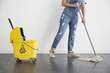 a woman mopping a floor 