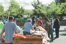 people distributing boxes of fruits and vegetables 