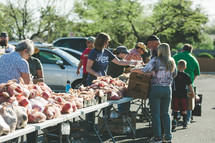 people shopping at a farmers market 