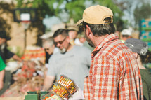 people shopping at a farmers market 