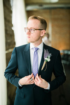 a man in a suit and tie with boutonniere