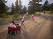 kids walking on a dirt road 