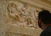 a man looking at a sculpture 