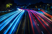 streaks of headlights and taillights on a highway at night 