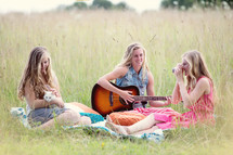 women sitting in a summer field 