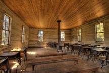 an old schoolhouse, desks, and wood stove 