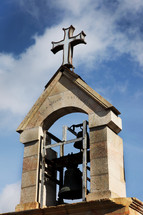 cross on top of a bell tower