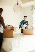 teen boys packing moving boxes 