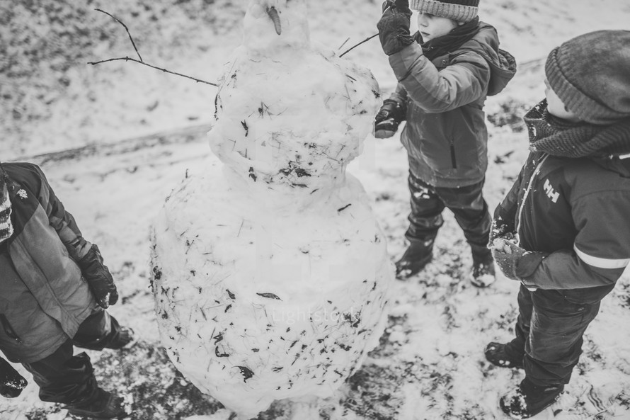 boys making a snowman 