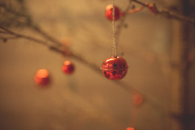 red bell ornament on a tree 