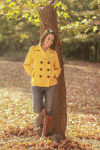smiling young woman standing outdoors in fall 