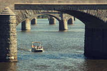 a boat going under a bridge 