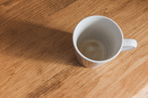 empty coffee mug on wood