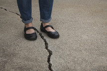 woman standing with a crack between her feet