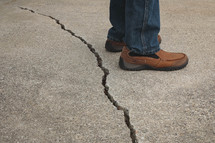 man standing beside of a crack 