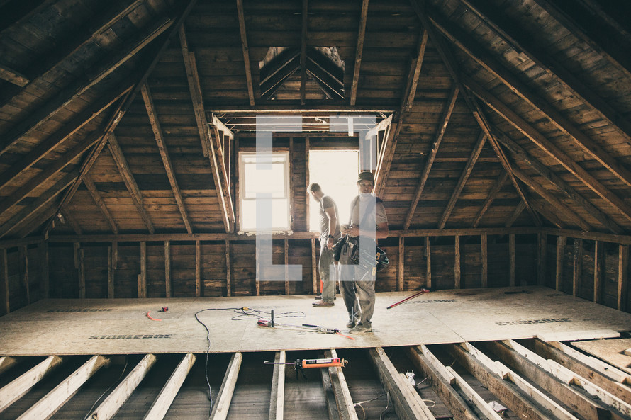 construction workers in an attic 