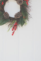 a Christmas wreath hanging on a front door 