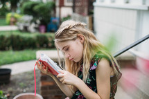 a little girl reading a Bible outdoors 