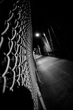 chain link fence in a dark alley 