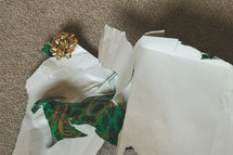 torn gift wrap on the floor 