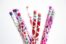Valentine's day themed pencils on a white background 