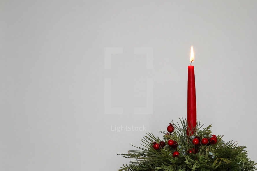 red Christmas candle against a white background 