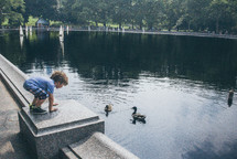 a child near a duck pond 