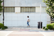 a woman walking on a sidewalk 