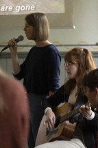 Young people playing and singing music during worship