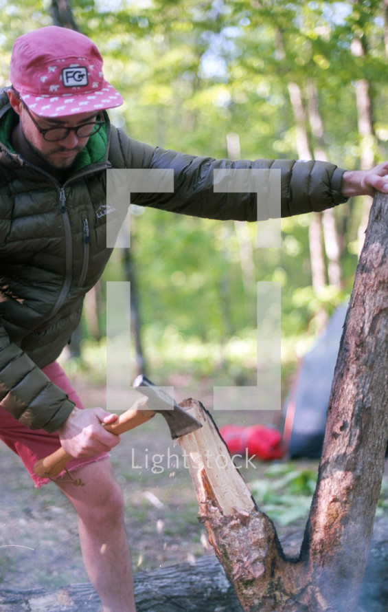 a man with an ax chopping down a tree 