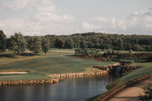 a wide view of a beautiful golf course with a lake