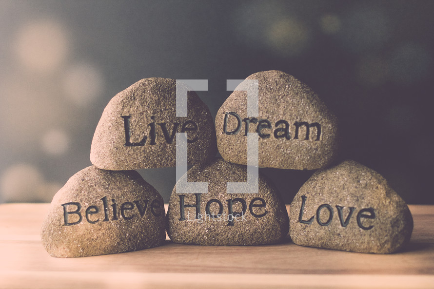 stones with the words live, believe, hope, love, and dream